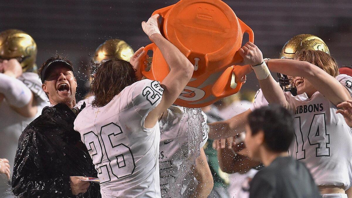Cardinal Gibbons’ head coach Steven Wright is given the celebratory Gatorade Bath by Savoy New (26) and Carson McDonald (14) after their win over Julius Chambers in the NCHSAA 4A Football Championship. The Cardinal Gibbons Crusaders and the Julius Chambers Cougars met in the NCHSAA 4A Football Championship game in Raleigh, N.C. on December 11, 2021.