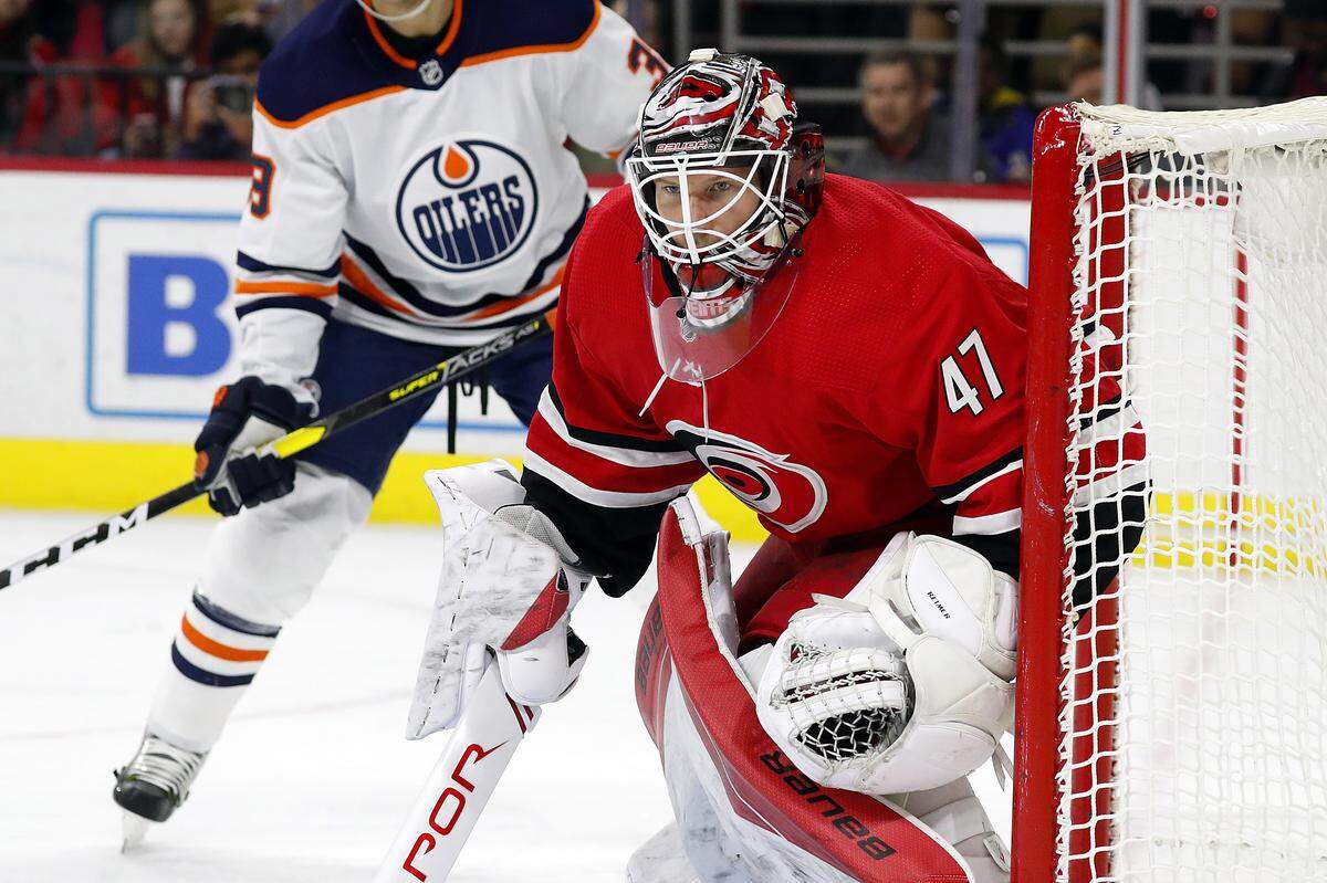 Carolina Hurricanes goaltender James Reimer (47) eyes the puck against the Edmonton Oilers during the first period of an NHL hockey game in Raleigh, N.C., Sunday, Feb. 16, 2020. (AP Photo/Karl B DeBlaker)