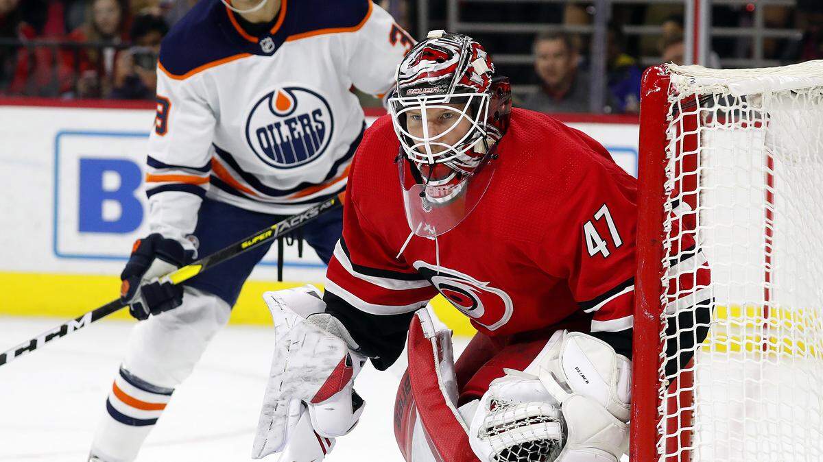 Carolina Hurricanes goaltender James Reimer (47) eyes the puck against the Edmonton Oilers during the first period of an NHL hockey game in Raleigh, N.C., Sunday, Feb. 16, 2020. (AP Photo/Karl B DeBlaker)