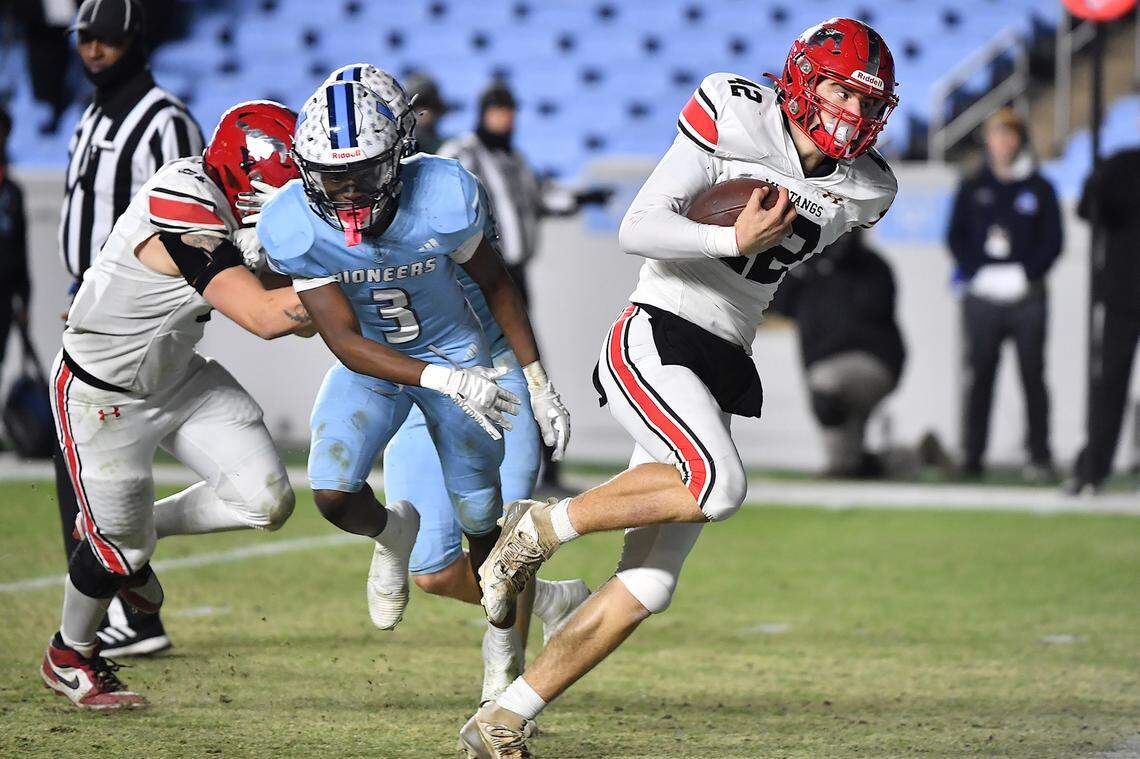 Middle Creek quarterback Ezra Jobe (42) runs for the touchdown against Watauga during the second half. The Middle Creek Mustangs and the Watauga Pioneers met in the NCHSAA 6A Football Championship game in Chapel Hill, N.C. on December 12, 2025. 