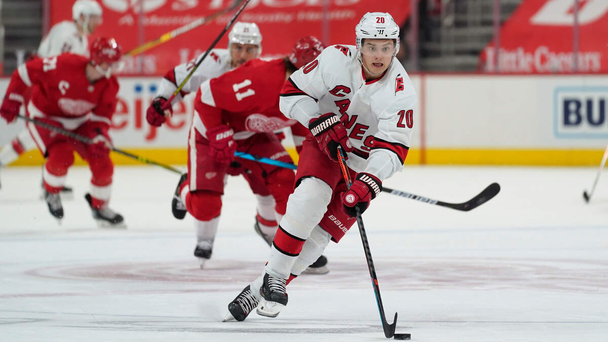 Carolina Hurricanes right wing Sebastian Aho (20) skates with the puck against the Detroit Red Wings in the first period of an NHL hockey game Tuesday, March 16, 2021, in Detroit. (AP Photo/Paul Sancya)