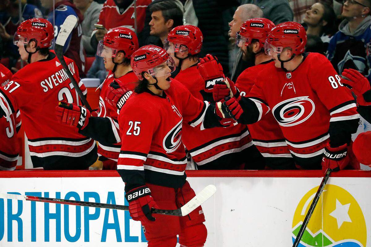 Carolina Hurricanes’ Ethan Bear (25) celebrates his goal along the bench during the third period of an NHL hockey game against the Colorado Avalanche in Raleigh, N.C., Thursday, March 10, 2022. (AP Photo/Karl B DeBlaker)