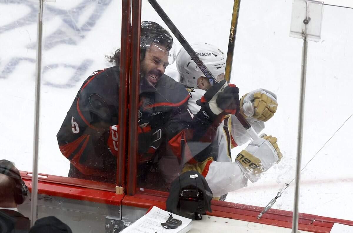 Vegas’ Ivan Barbashev (49) checks Carolina's Jalen Chatfield (5) in the second period of the Hurricanes’ game against the Golden Knights in the fifth game of the Stanley Cup Final at the Lenovo Center in Raleigh, N.C., Thursday, June 11, 2026.