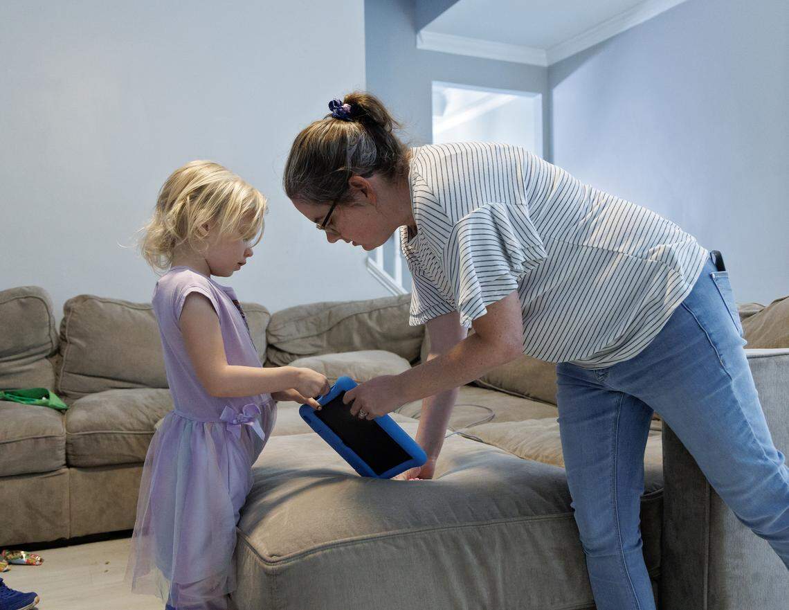 Brittany Futch talks with her daughter, Arya, 6, in Wake Forest. Futch is lobbying to get the Wake County school system to restore an aide’s position in Arya’s classroom at Heritage Elementary School. Arya has run away from her classroom multiple times since the aide was removed.