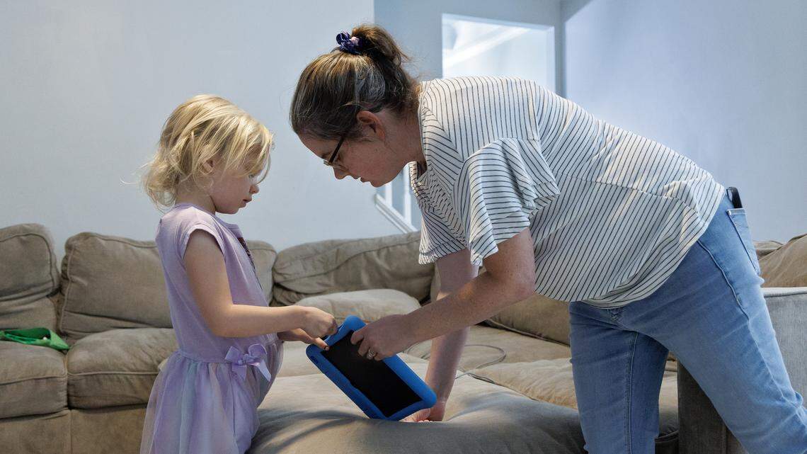 Brittany Futch talks with her daughter, Arya, 6, at their home on Wednesday, Aug. 27, 2025, in Wake Forest, N.C. Futch is lobbying to get the Wake County school system to restore an extra aide’s position in Arya’s classroom at Heritage Elementary School. Arya has run away from her classroom multiple times since the aide was removed.