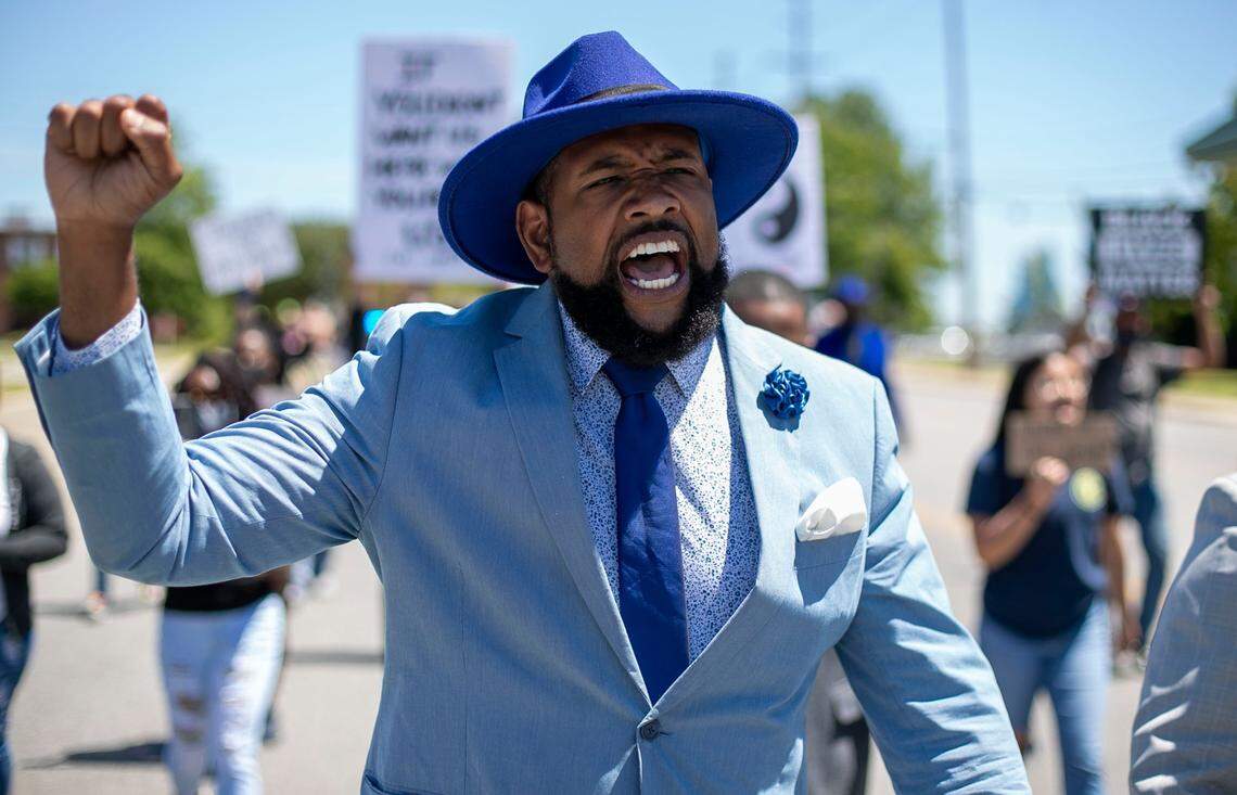 Shawntrell Paige with Suited Movement 757 chants with demonstrators as they march along Eringhuas Street on Saturday, May 1, 2021 in Elizabeth City, N.C. This is the eleventh day demonstrators have gathered in Elizabeth City following the death of Andrew Brown Jr. at the hands of Pasquotank County deputies.
