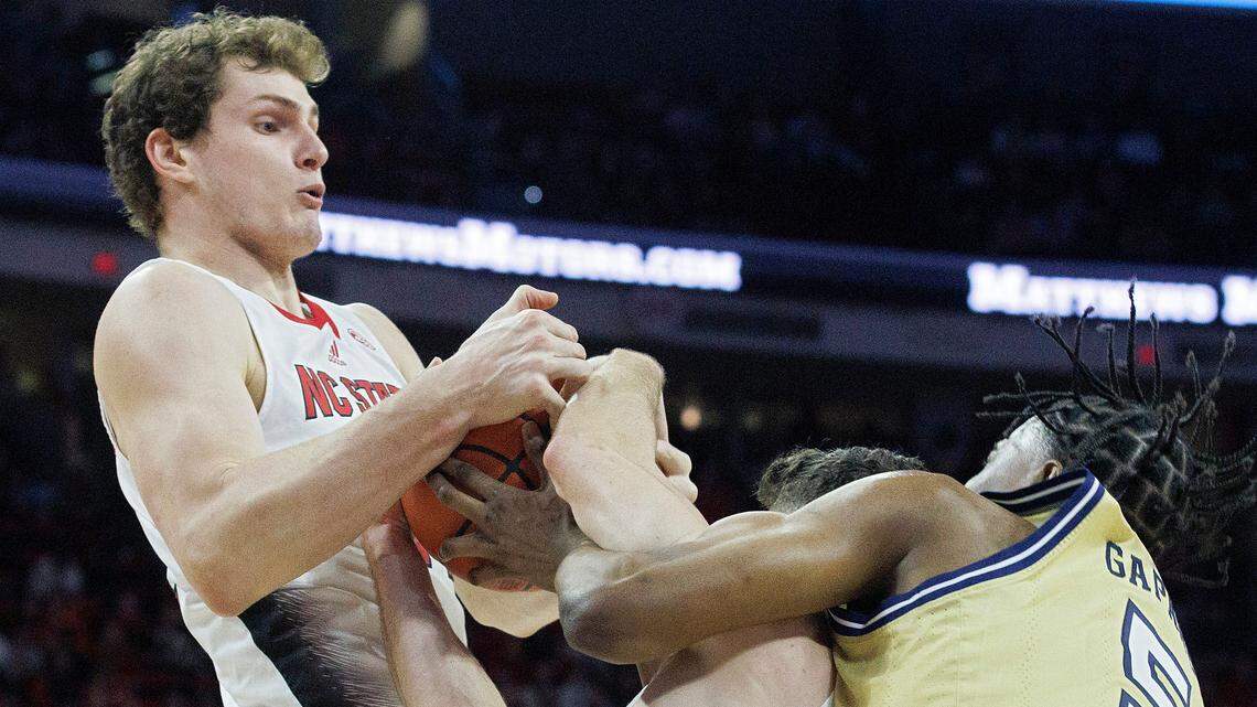 N.C. State’s Ben Middlebrooks and Michael O’Connell tangle with Georgia Tech’s Tafara Gapare for a loose ball during the second half of the Wolfpack’s 82-76 win on Saturday, Feb. 3, 2024, at PNC Arena in Raleigh, N.C.