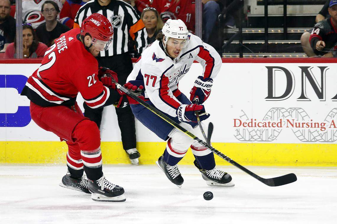 CORRECTS DATE TO SUNDAY, SEPT. 29, 2019 Washington Capitals’ T.J. Oshie (77) battles with Carolina Hurricanes’ Brett Pesce (22) during the first period of an NHL preseason hockey game, in Raleigh, N.C., Sunday, Sept. 29, 2019. (AP Photo/Karl B DeBlaker)