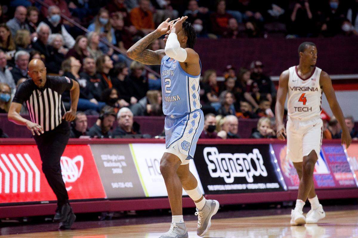 North Carolina’s Caleb Love celebrates a 3-pointer against Virginia Tech during the first half of an NCAA college basketball game at Cassell Coliseum, Saturday, Feb. 19, 2022, in Blacksburg, Va. (Scott P. Yates/The Roanoke Times via AP)