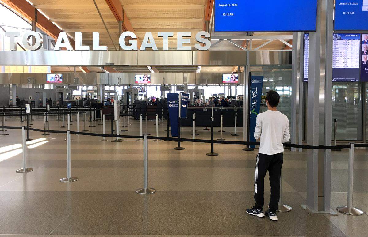 There are only a few people in line at the security checkpoint in Terminal 2 at Raleigh-Durham International Airport Wednesday morning around 10 a.m., August 12, 2020.