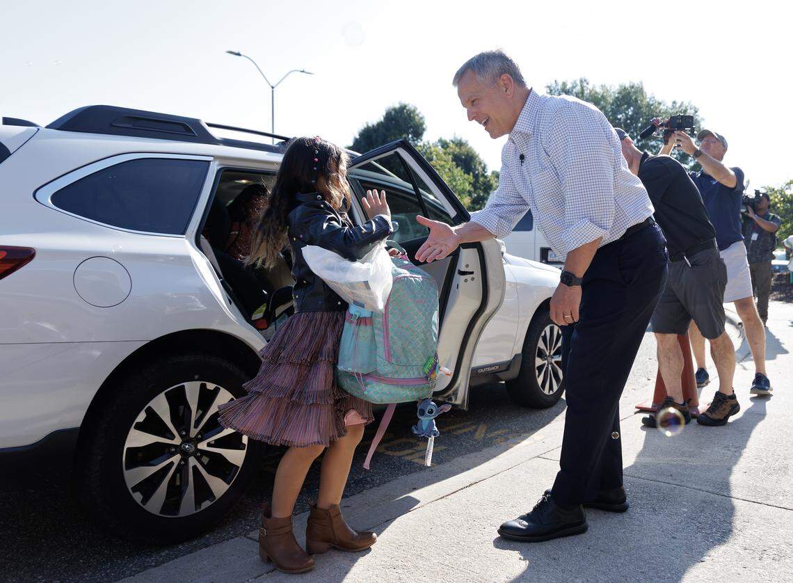 Aralyn Leong, a second grade student at Washington Elementary School, greets Gov. Josh Stein on the first day of school on Monday, Aug. 25, 2025, in Raleigh, N.C. 