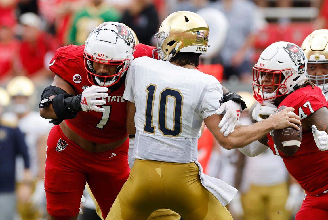 N.C. State defensive tackle Davin Vann (1) sacks Notre Dame quarterback Sam Hartman (10) during the first half of N.C. State’s game against Notre Dame at Carter-Finley Stadium in Raleigh, N.C., Saturday, Sept. 9, 2023.