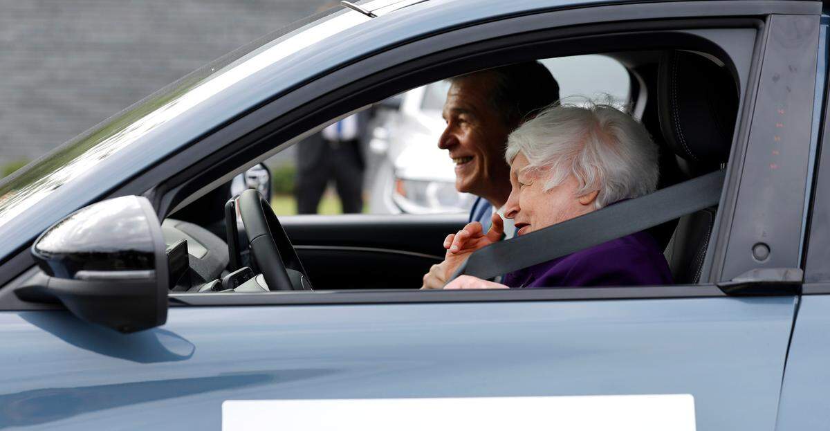 Treasury Secretary Janet Yellen laughs with Gov. Roy Cooper after she test drove an EV Ford Mustang Mach-E at Wake Tech’s East Campus in Wendell Thursday, Sept. 5, 2024.