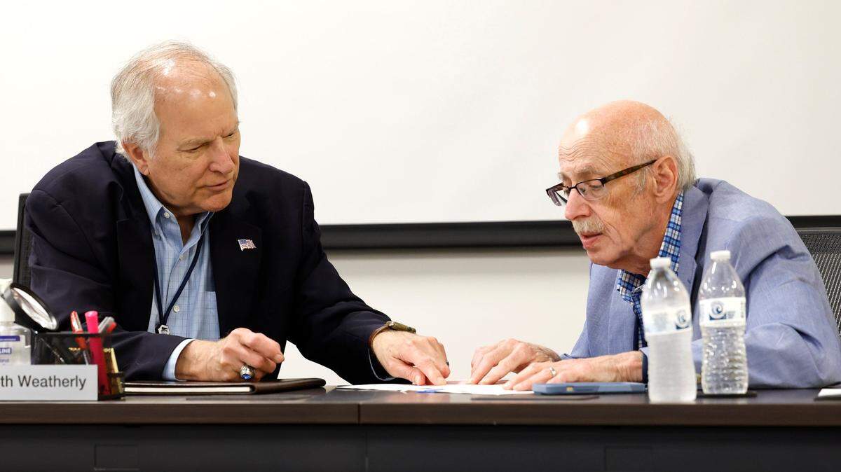 Wake County Board of Elections board members Keith Weatherly, left, and Gerry Cohen review an absentee ballot during a Wake County Board of Elections board meeting at the operations center in Raleigh, N.C., Tuesday, May 7, 2024.