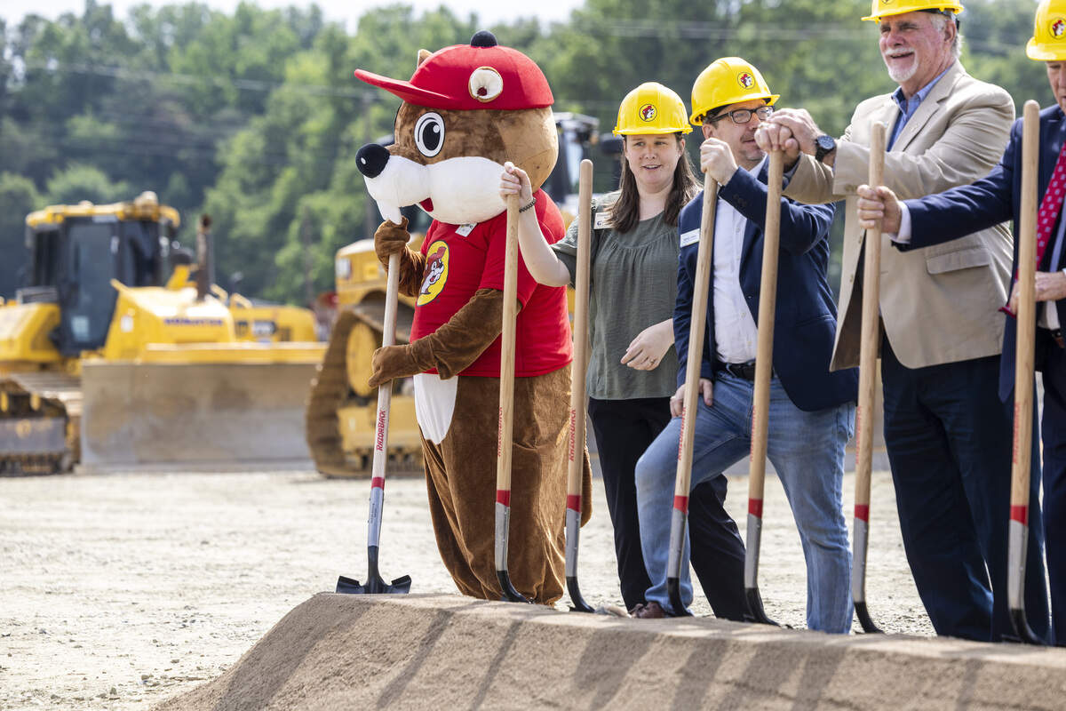 The Buc-ee's beaver mascot and local officials shovel dirt during a groundbreaking ceremony for the Buc-ee's travel center in Mebane.