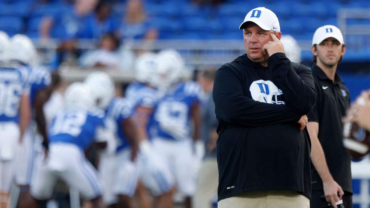 Duke head coach Mike Elko watches as the Blue Devils warm up prior to their season opener against Temple at Wallace Wade Stadium on Friday, Sept. 2, 2022, in Durham, N.C.