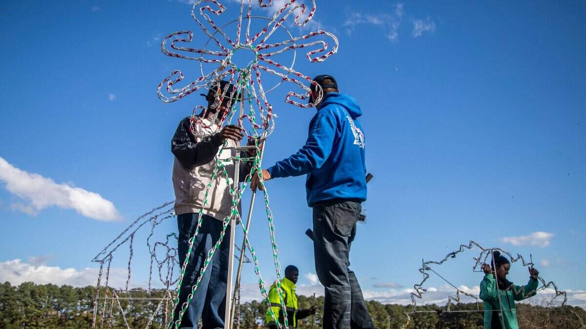 From left, Mardray Glenn, Thomas Duke, Jesse Bartholomew and Iris Lloyd install Christmas lights on a 1.3 mile route at Dorothea Dix Park. Monday, Nov. 30, 2020. The drive-thru holiday light show sponsored by WRAL in partnership with the City of Raleigh will operate nightly from Wednesday, Dec. 16, through Thursday, Dec. 31, 2020.