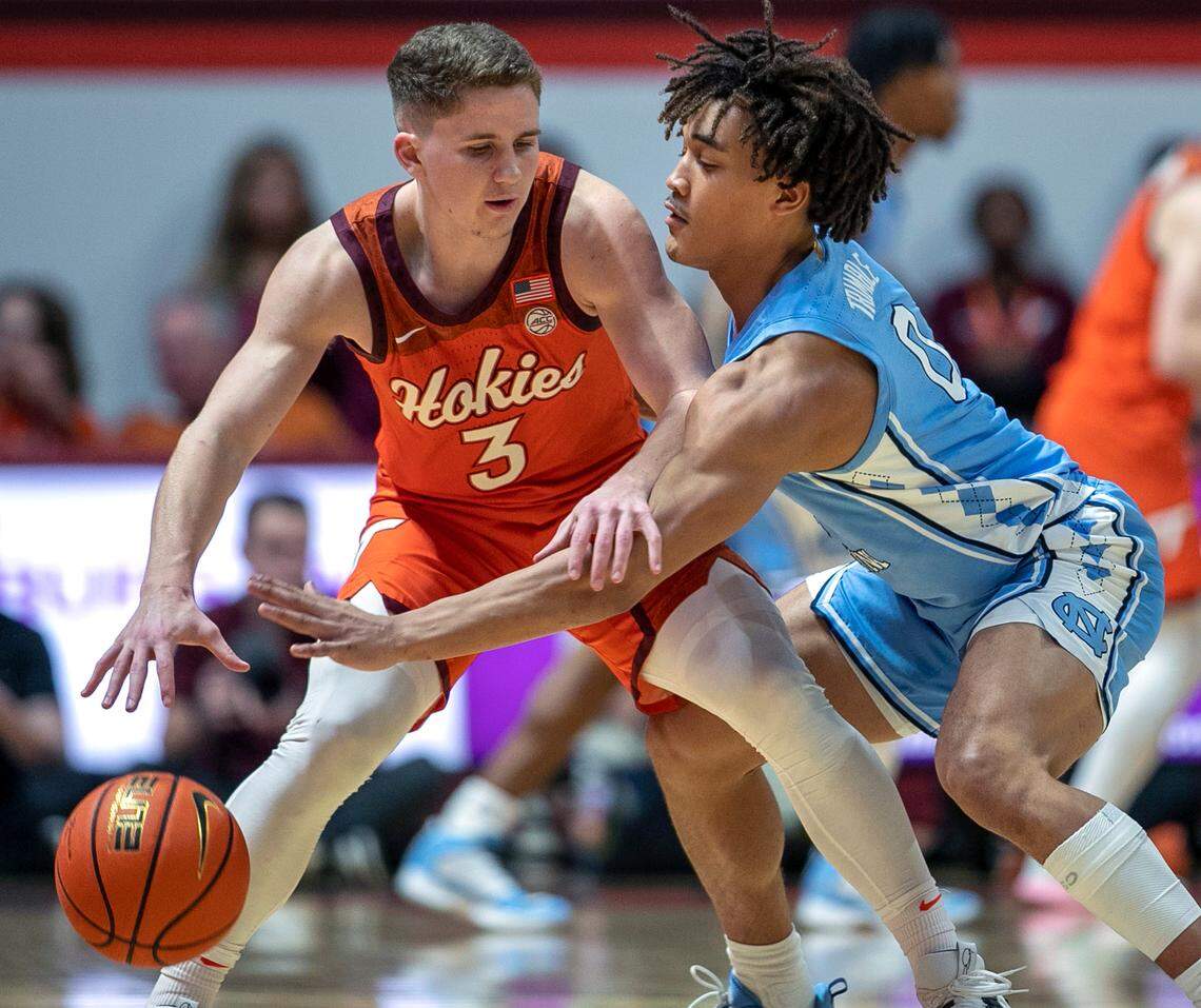 North Carolina’s Seth Trimble (0) forces a turnover by Virginia Tech’s Sean Pedulla (3) during the second half on Sunday, December 4, 2022 at Cassell Coliseum in Blacksburg, Va.
