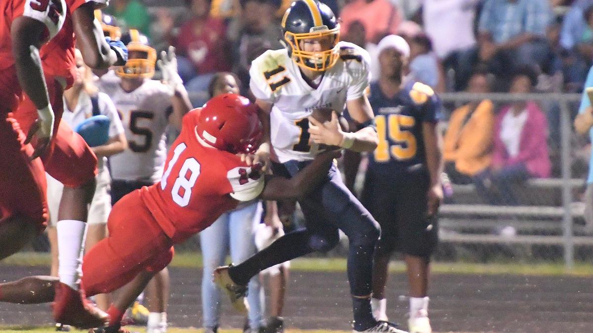 Kyle Barnhill (11) of Northern Durham gains yards against Marcus Greene (18) of Jordan. The Northern Durham Knights visited the Jordan Falcons in a high school football game on September 6, 2019.