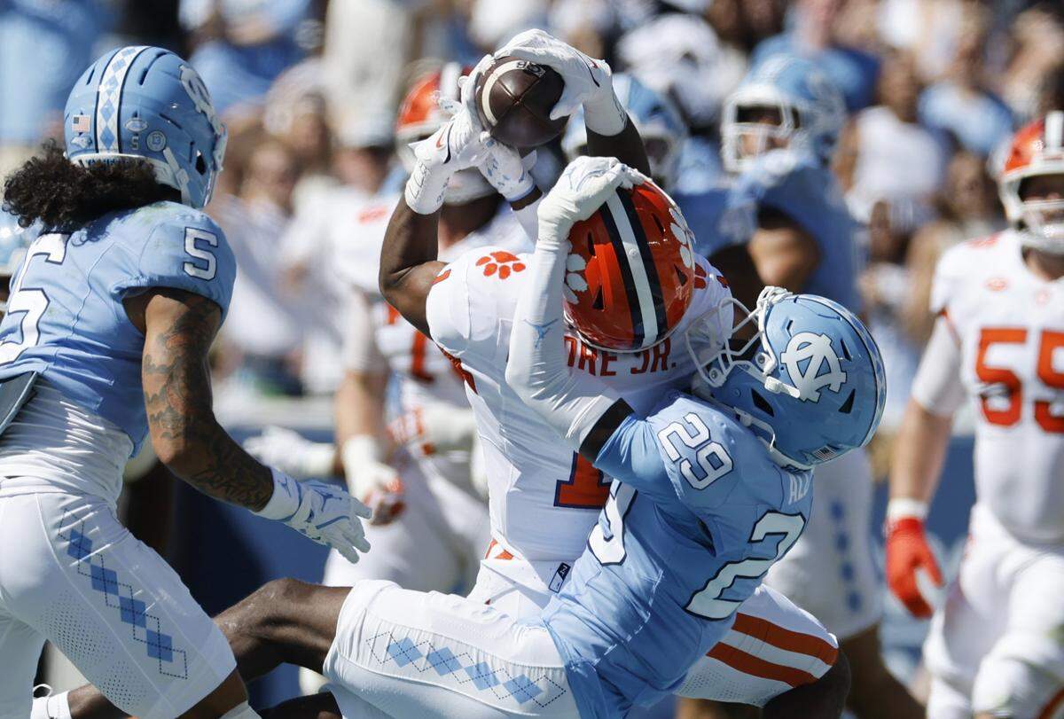 Clemson wide receiver T.J. Moore (1) pulls in a reception while defended by North Carolina defensive back Marcus Allen (29) during the first half of UNC’s game against Clemson at Kenan Stadium in Chapel Hill, N.C., Sat. Oct. 4, 2025.