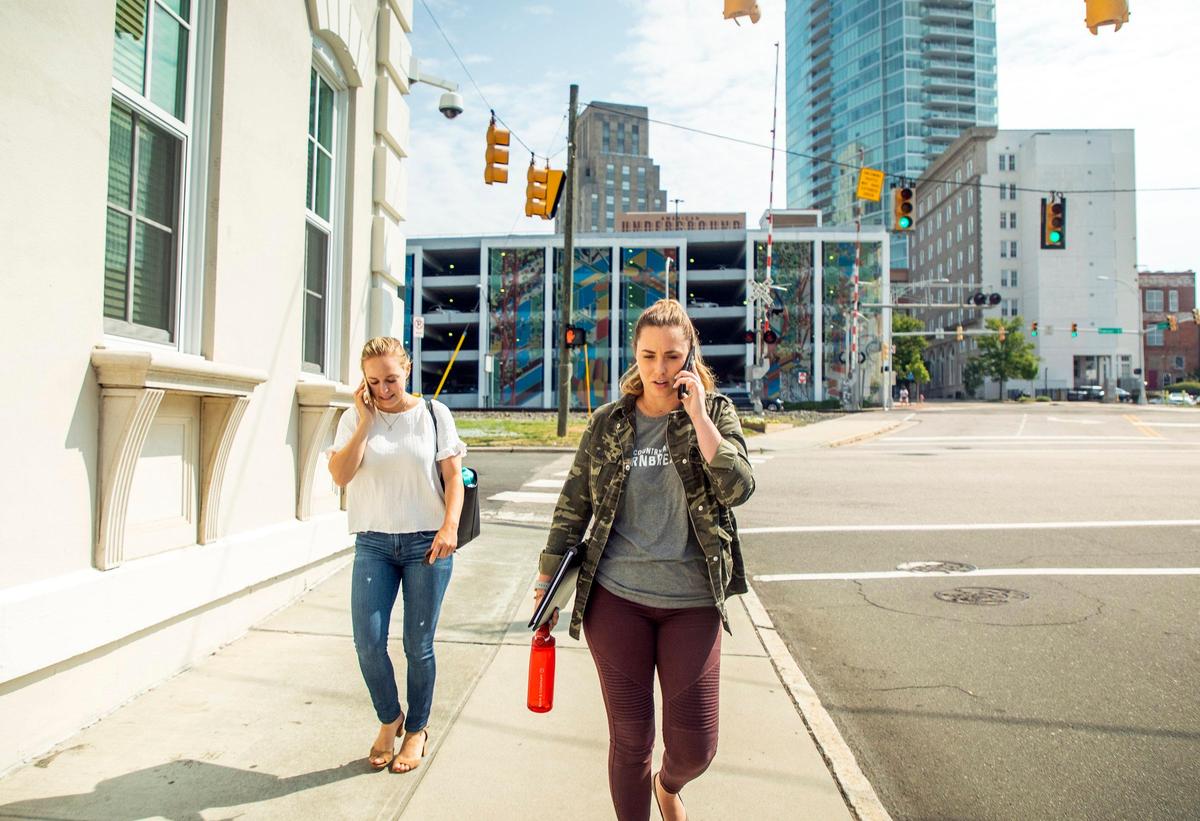 Leigh-Kathryn Bonner, right, founder and CEO of Bee Downtown, and regional account manager Scottie McLeod, walk from their office in American Underground to a training for startups about on-boarding new employees in the American Tobacco district, on Thursday, Jun. 6, 2019, in Durham, NC.