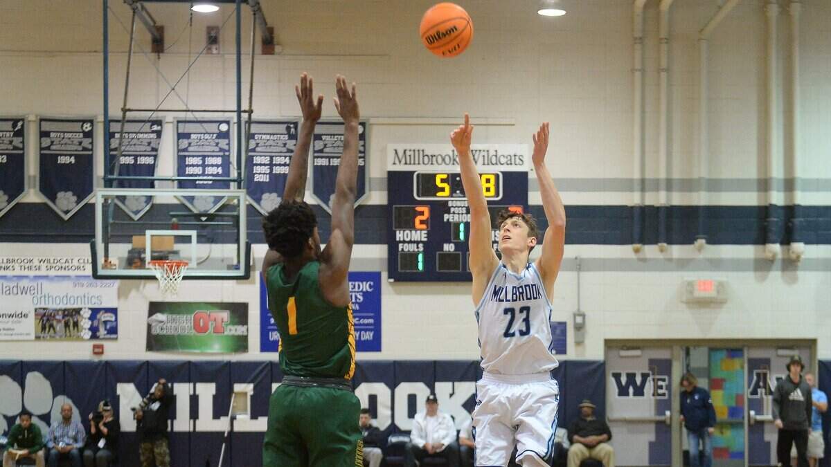 Eric van der Heijden (23) of Millbrook scores two points against Juwelz Hargrove (1) of Smith. The Millbrook Wildcats played the Smith Golden Eagles in a boys basketball game that was part of the Millbrook Showcase on December 7, 2019.