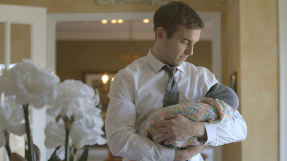 In a reenactment in the Investigation Discovery series “Fatal Passions,” an actor portraying Eric Miller holds his baby daughter, Clare. The real-life Miller was found dead.