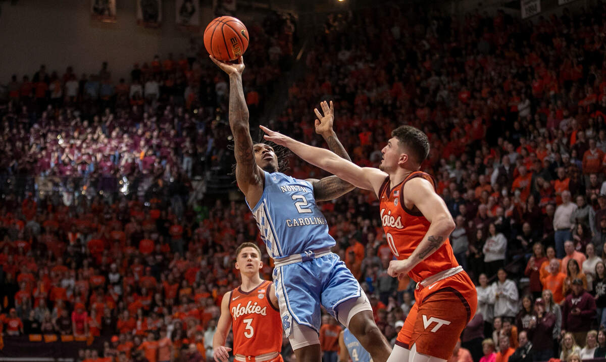 North Carolina’s Caleb Love (2) drives to the basket against Virginia Tech’s Hunter Cattoor (0) during the first half on Sunday, December 4, 2022 at Cassell Coliseum in Blacksburg, Va.