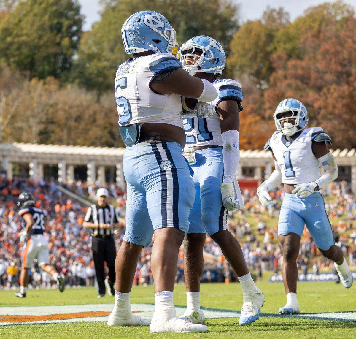 North Carolina defensive back Kaleb Cost (21) celebrates with defensive lineman Jahvaree Ritzie (5) after his 84-yard interception return for a touchdown in the third quarter to give the Tar Heels’ a 38-6 lead against Virginia on Saturday, October 26, 2024 at Scott Stadium in Charlottesville, Va.