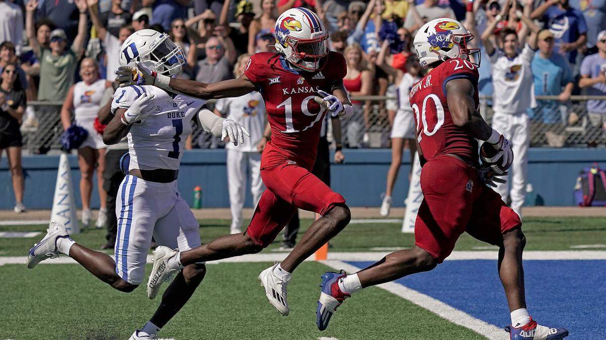 Kansas running back Daniel Hishaw Jr. (20) scores a touchdown during the first half of an NCAA college football game against Duke Saturday, Sept. 24, 2022, in Lawrence, Kan. (AP Photo/Charlie Riedel)