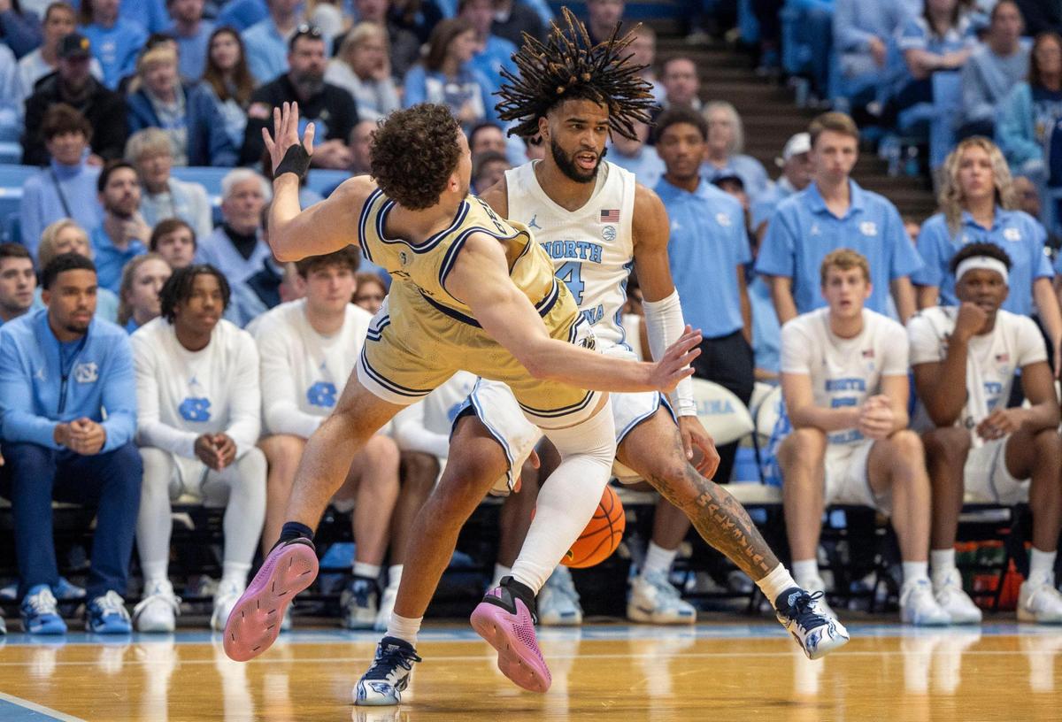 Georgia Tech’s forward Lance Terry (0) is called for blocking North Carolina guard R.J. Davis in the second half on Saturday, December 7, 2024 at the Smith Center in Chapel Hill, N.C.