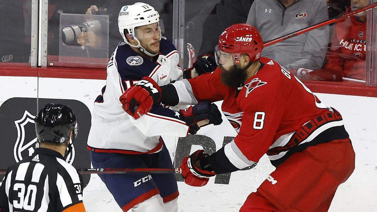 Carolina defenseman Brent Burns (8) tangles with Columbus right wing Justin Danforth (17) during the third period of the Carolina Hurricanes’ 4-1 victory over the Columbus Blue Jackets at PNC Arena in Raleigh, N.C., Wednesday, Oct. 12, 2022.