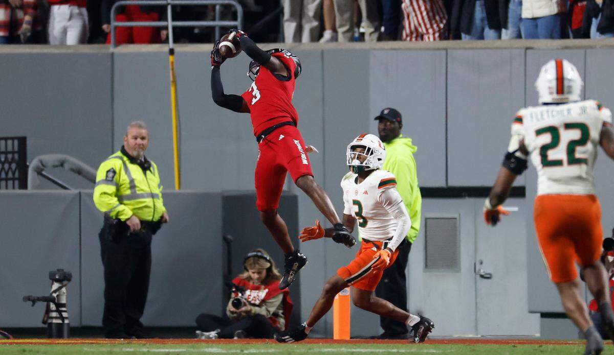 N.C. State cornerback Aydan White (3) intercepts a ball intended for Miami wide receiver Jacolby George (3) during the first half of N.C. State’s game against Miami at Carter-Finley Stadium in Raleigh, N.C., Saturday, Nov. 4, 2023.