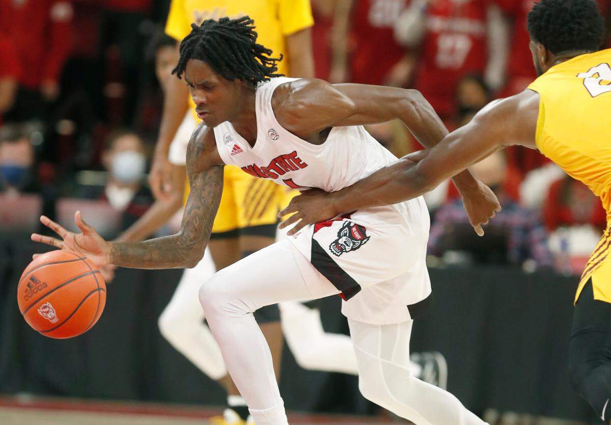N.C. State’s Dereon Seabron (1) steals the ball from Bethune-Cookman’s Jakolby Long (2) during the first half of N.C. State’s game against Bethune-Cookman University at Reynolds Coliseum in Raleigh, N.C., Thursday, December 9, 2021.
