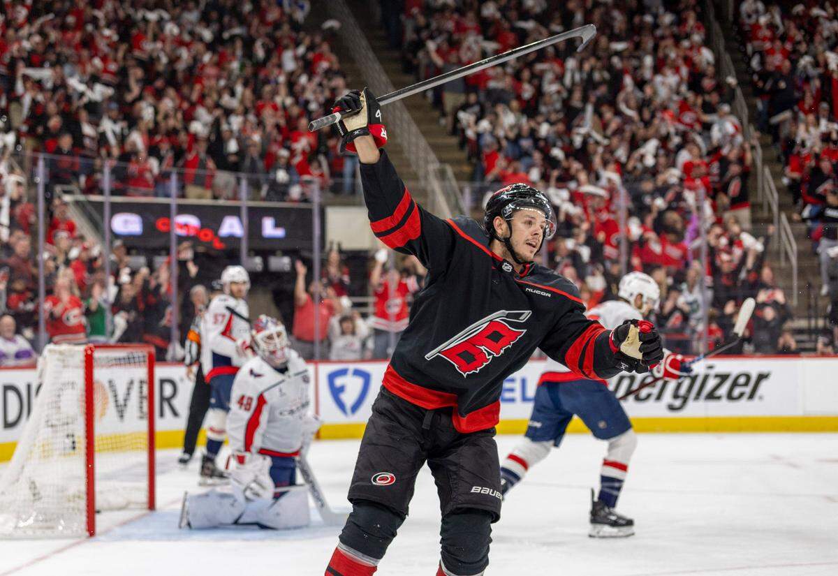 Carolina Hurricanes center Jesperi Kotkaniemi (82) reacts after a goal by teammate Shaye Gostisbehere (04) in the first period, to take a 1-0 lead against the Washington Capitals during Game 4 of their series on Monday, May 12, 2025 at Lenovo Center in Raleigh, N.C.
