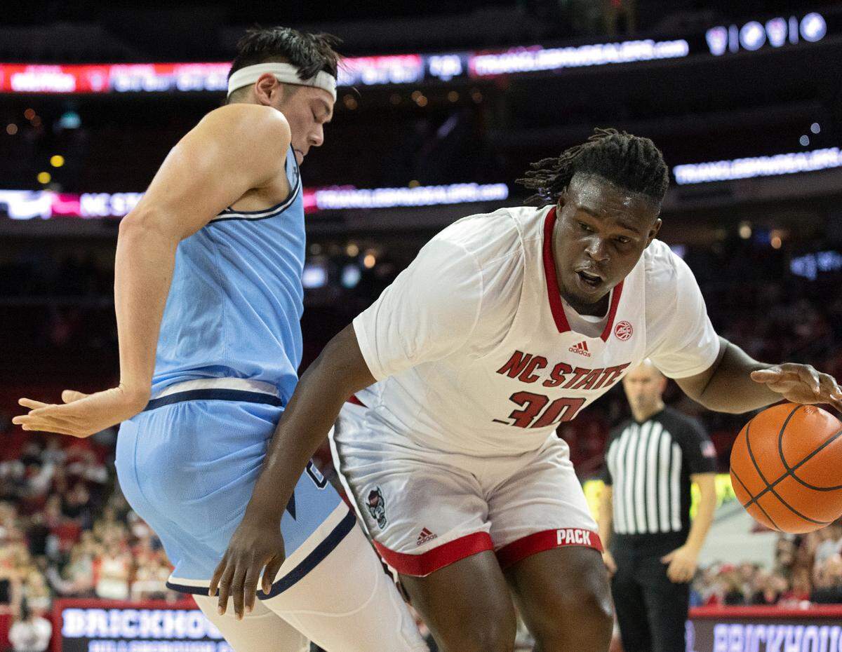 N.C. State’s DJ Burns Jr. drives baseline past the Citadel’s Quentin Millora-Brown during the first half of the Wolfpack’s season opener against The Citadel on Monday, Nov. 6, 2023, at PNC Arena in Raleigh, N.C.