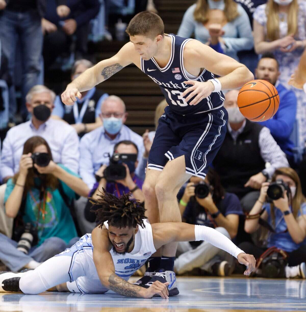 North Carolina’s RJ Davis (4) loses the ball as Dukes Joey Baker (13) defends during the first half of UNCs game against Duke at the Smith Center in Chapel Hill, N.C., Saturday, Feb. 5, 2022.