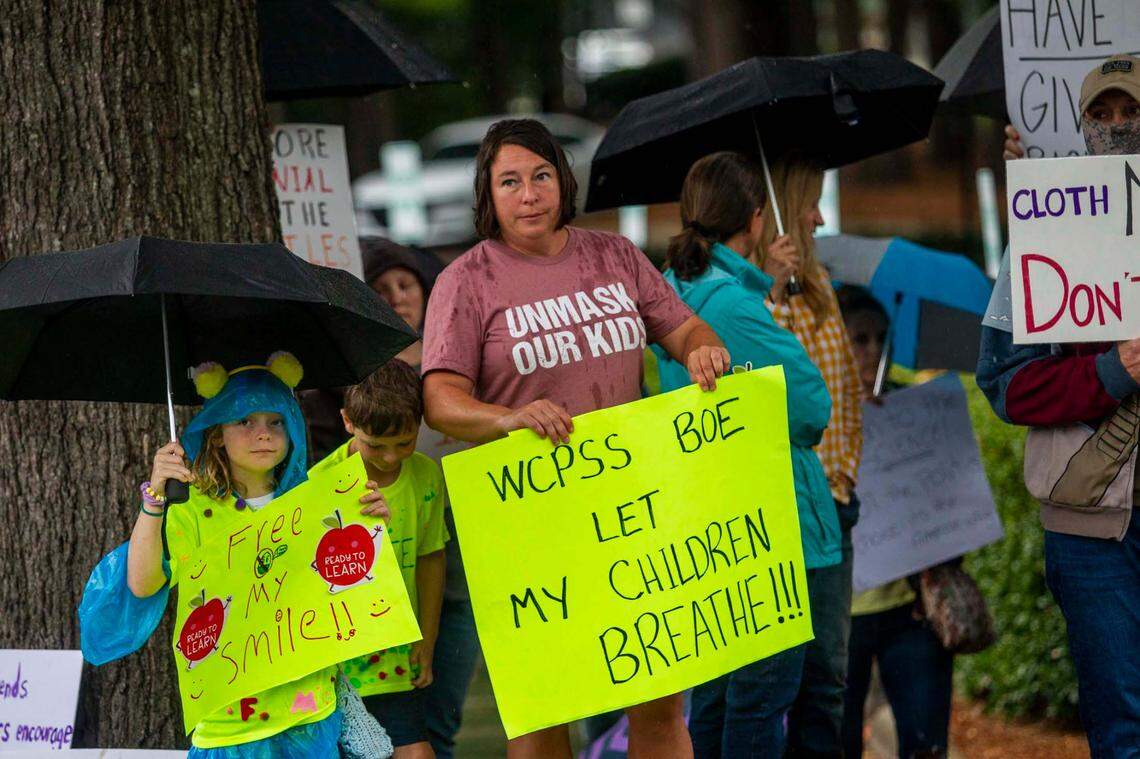 Protesters and counter-protesters demonstrate outside a Wake County Board of Education meeting Tuesday, Aug. 3, 2021 in Cary. The board will vote on a proposal to continue to require face masks in schools. Some parents argue the coverings should be optional.