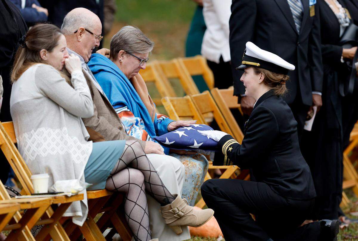 The Navy honor guard presents Mary Marshall’s family an American flag during a memorial service for Marshall at Dix Park in Raleigh, N.C., Saturday, Oct. 29, 2022. Marshall was one of the five people killed in a mass shooting on Oct. 13.