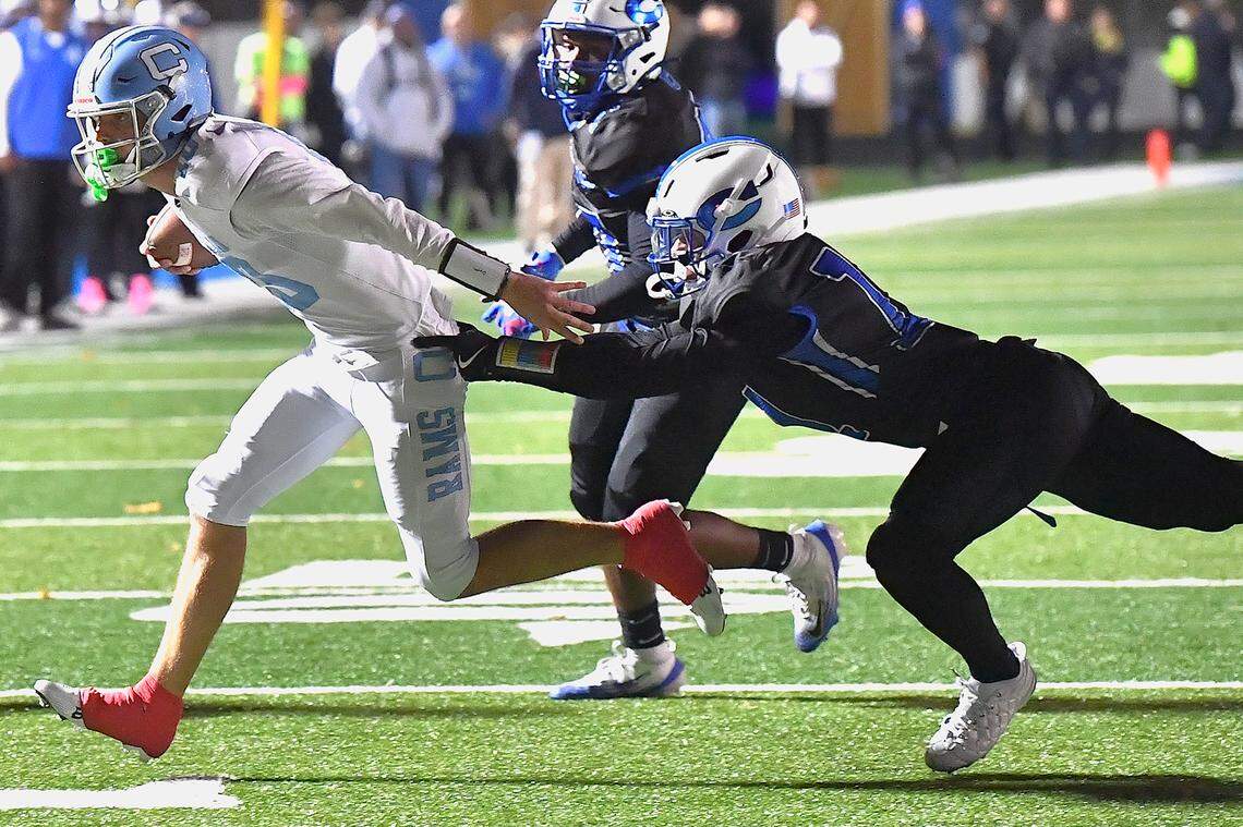 Cleveland quarterback Owen Hulbert (10) runs against the defense from Clayton's Christian Schmidt (11) late in the first half. The Cleveland Rams took on the Clayton Comets in a conference football game in Clayton, N.C. on October 31st in Clayton, N.C.