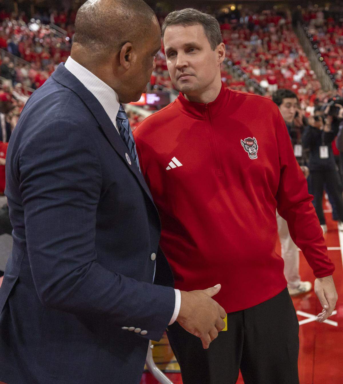 N.C. State coach Will Wade greets North Carolina coach Hubert Davis prior to their game on Tuesday, February 17, 2026 at Lenovo Center in Raleigh, N.C.