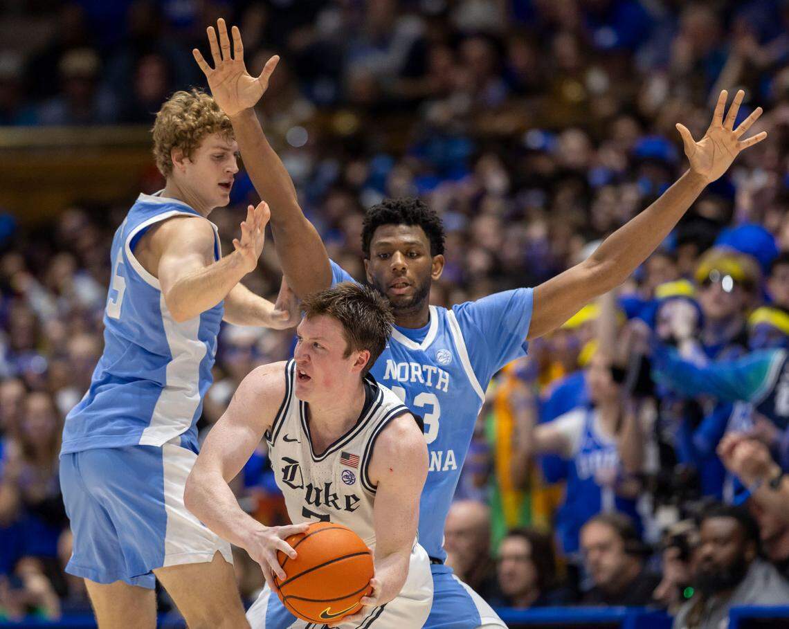 Duke’s Kon Knueppel (7) works his way out of a trap by North Carolina’s Jalen Washington (13) and Cade Tyson (5) in the second half on Saturday, February 1, 2025 at Cameron Indoor Stadium in Durham, N.C.