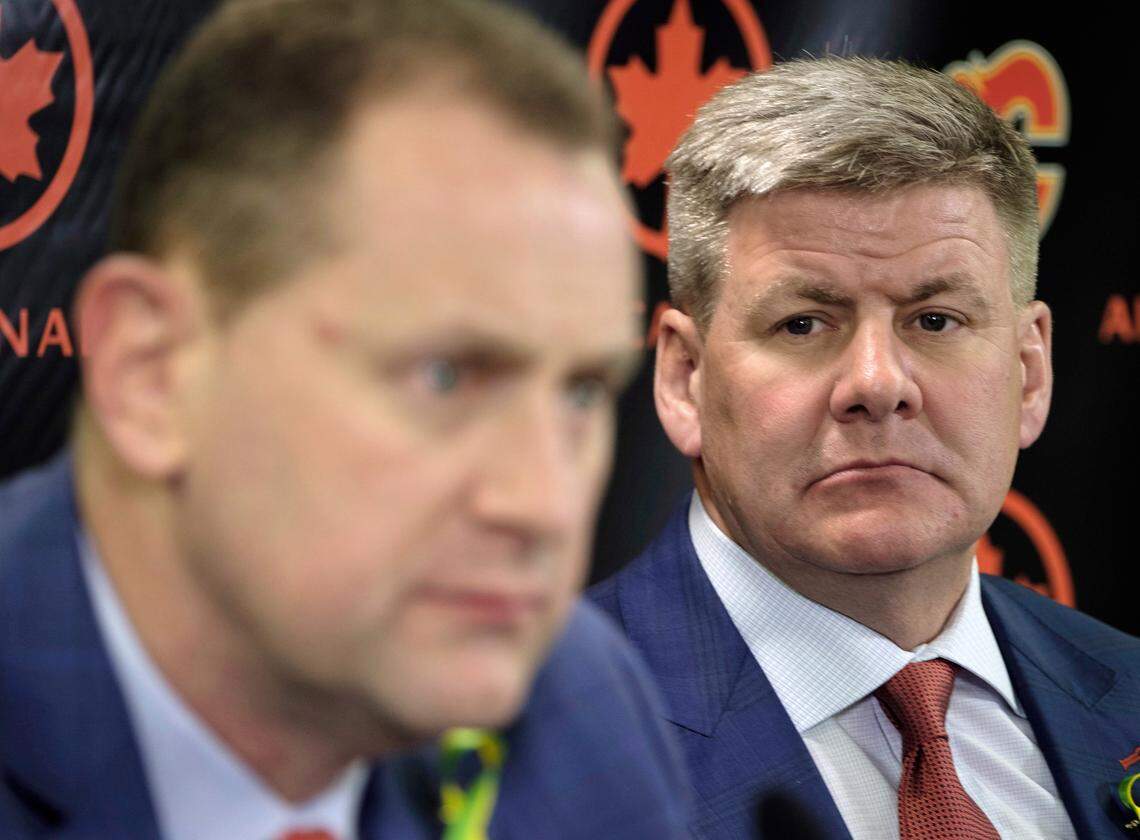 Calgary Flames' general manager Brad Treliving, left, announces Bill Peters, right, as the NHL hockey team's new head coach in Calgary, Alberta, Monday, April 23, 2018.
