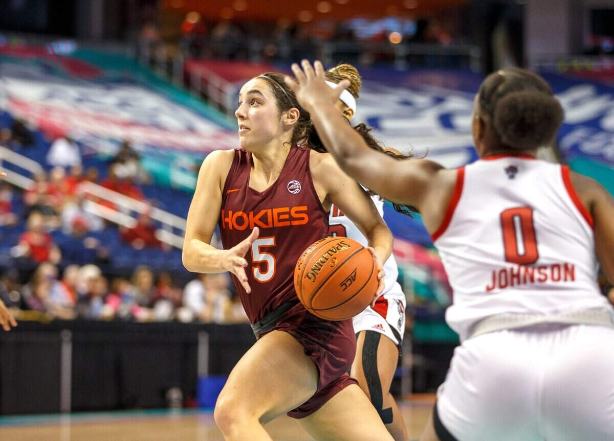Virginia Tech guard Georgia Amoore (5) drives to the basket through North Carolina State defenders during the first half of an NCAA college basketball game in the semifinals of the Atlantic Coast Conference women’s tournament in Greensboro, N.C., Saturday, March 5, 2022. (AP Photo/Lynn Hey)