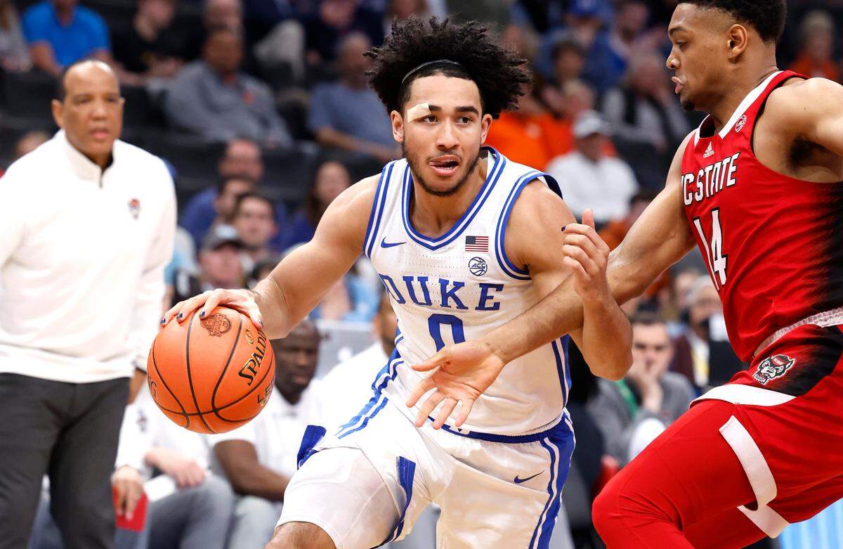 Duke’s Jared McCain (0) drives by N.C. State’s Casey Morsell (14) during the first half of N.C. State’s game against Duke in the quarterfinal round of the 2024 ACC Men’s Basketball Tournament at Capital One Arena in Washington, D.C., Thursday, March 14, 2024.