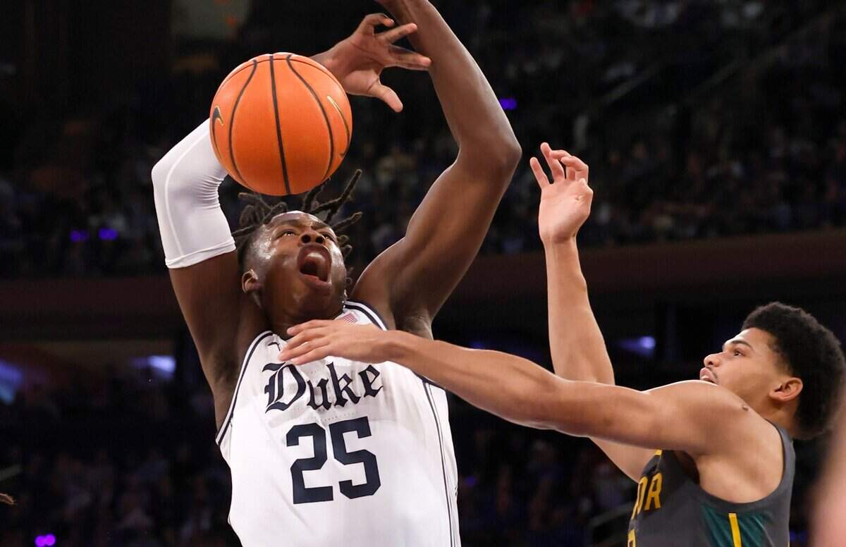 Duke’s Mark Mitchell (25) loses the ball as he is defended by Baylor’s RayJ Dennis (10) during the first half of Duke’s game against Baylor at Madison Square Garden in New York City Wednesday, Dec. 20, 2023.