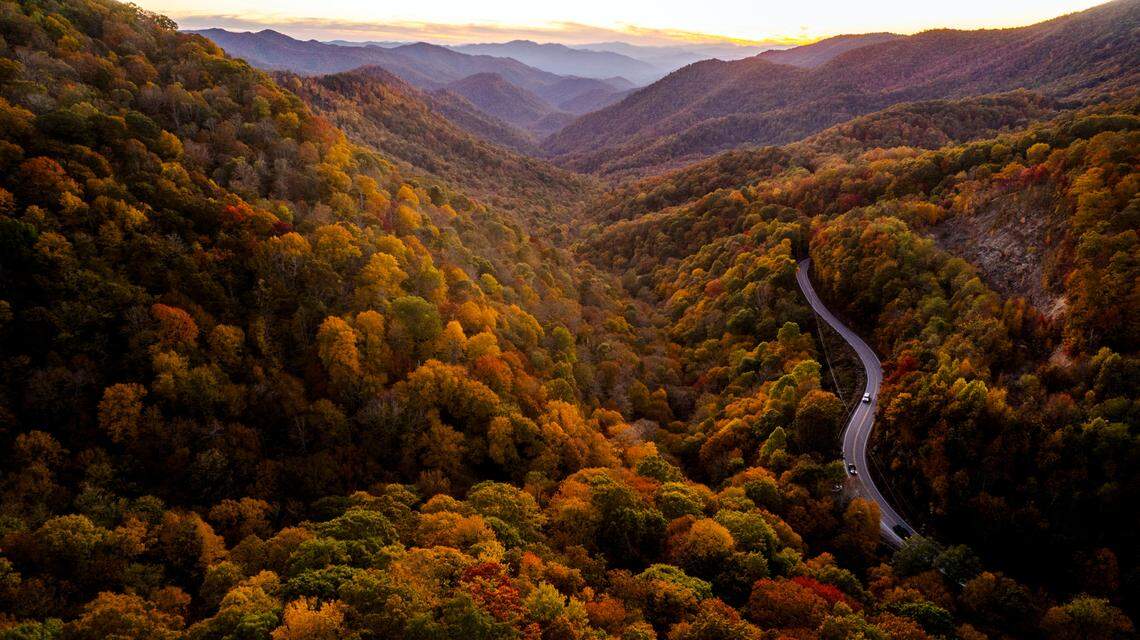 An aerial photo of the sun setting along U.S. 19 in Cherokee, as fall color peaks in the North Carolina mountains in this file photo.