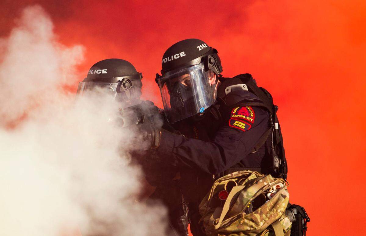 Police in riot gear deploy tear, gas pepper spray and smoke bombs against protesters near the intersection of McDowell and Davie Streets in downtown Raleigh Saturday, May 30, 2020.