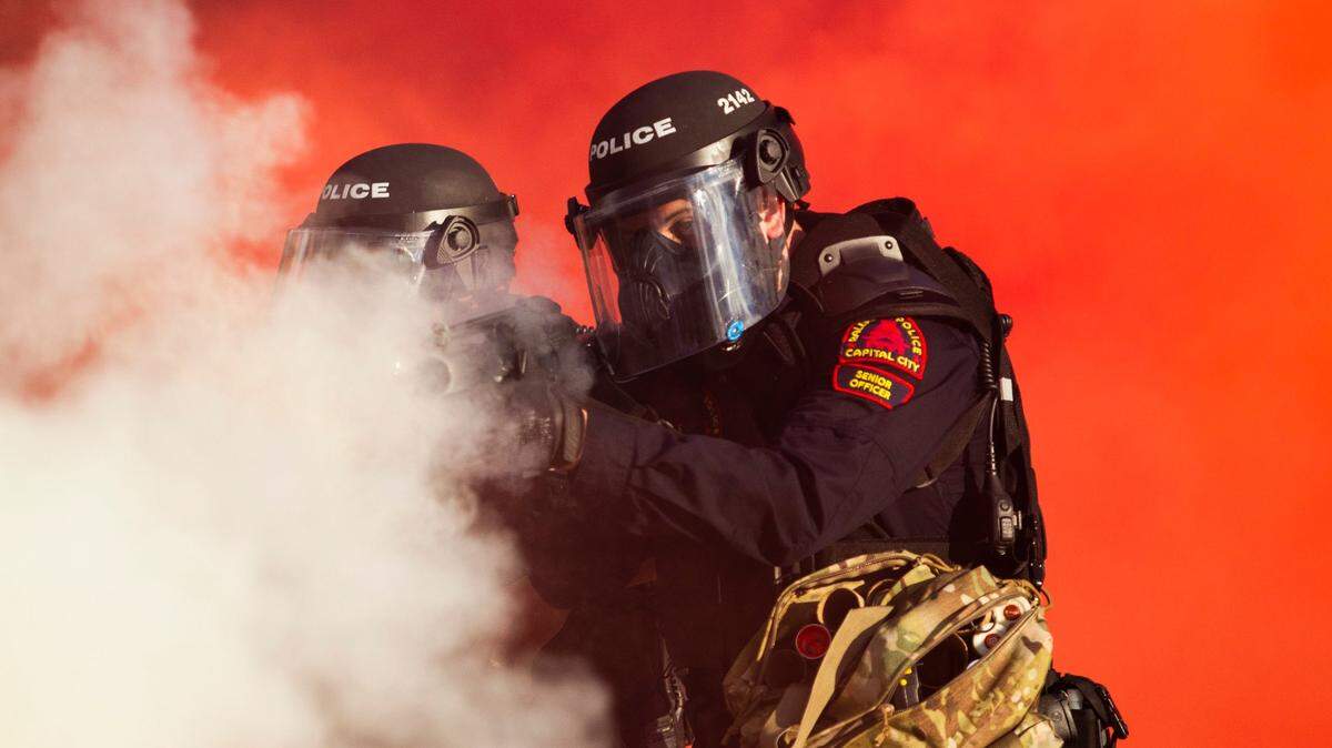 Police in riot gear deploy tear, gas pepper spray and smoke bombs against protesters near the intersection of McDowell and Davie Streets in downtown Raleigh Saturday, May 30, 2020.