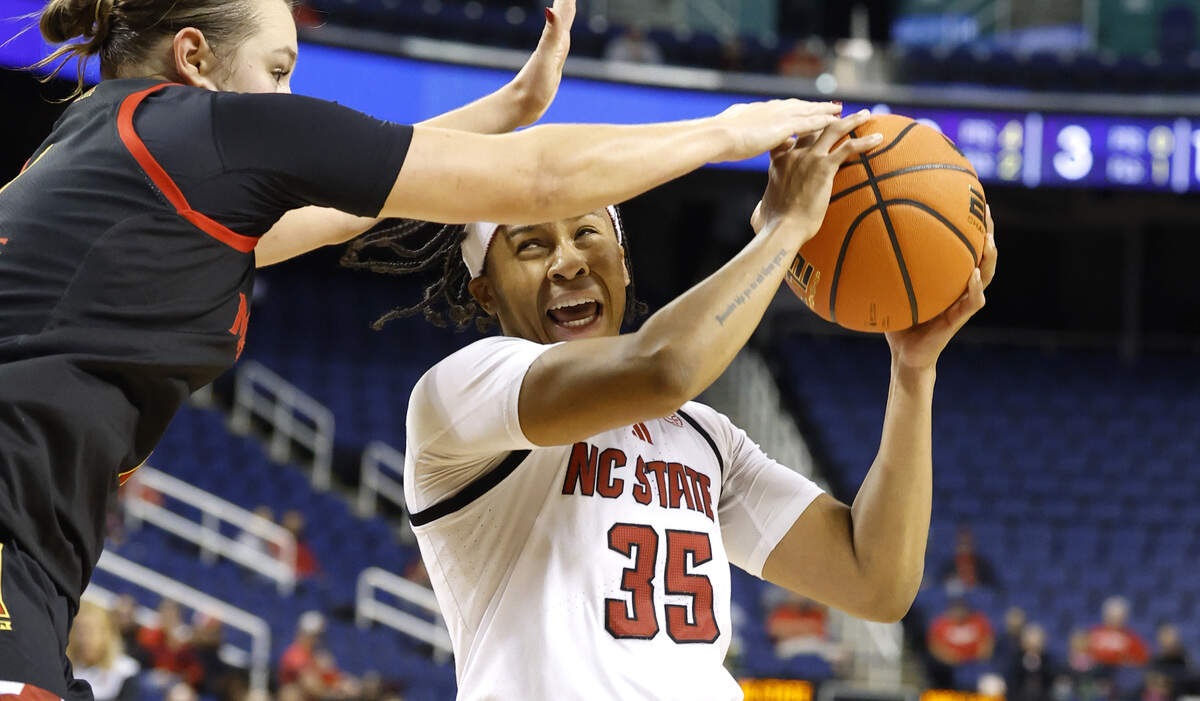 N.C. State's Zoe Brooks rives past Maryland's Lea Bartelme to shoot in the Wolfpack’s 83-75 exhibition win over the Terrapins.